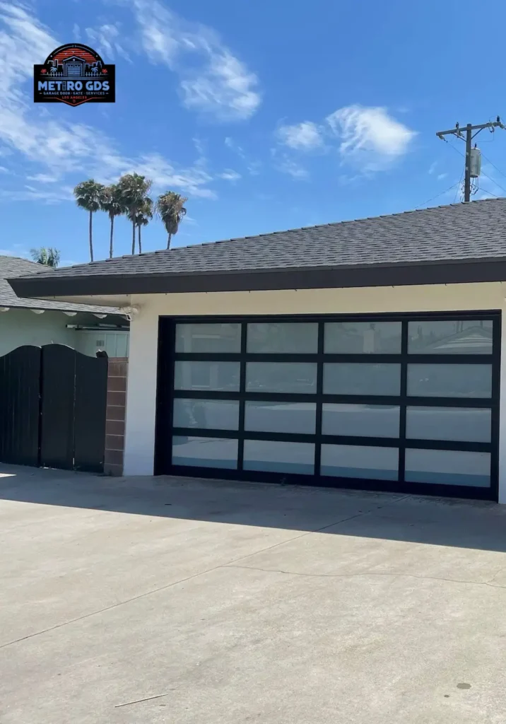Contemporary black and glass garage door installed by Metro GDS Inc