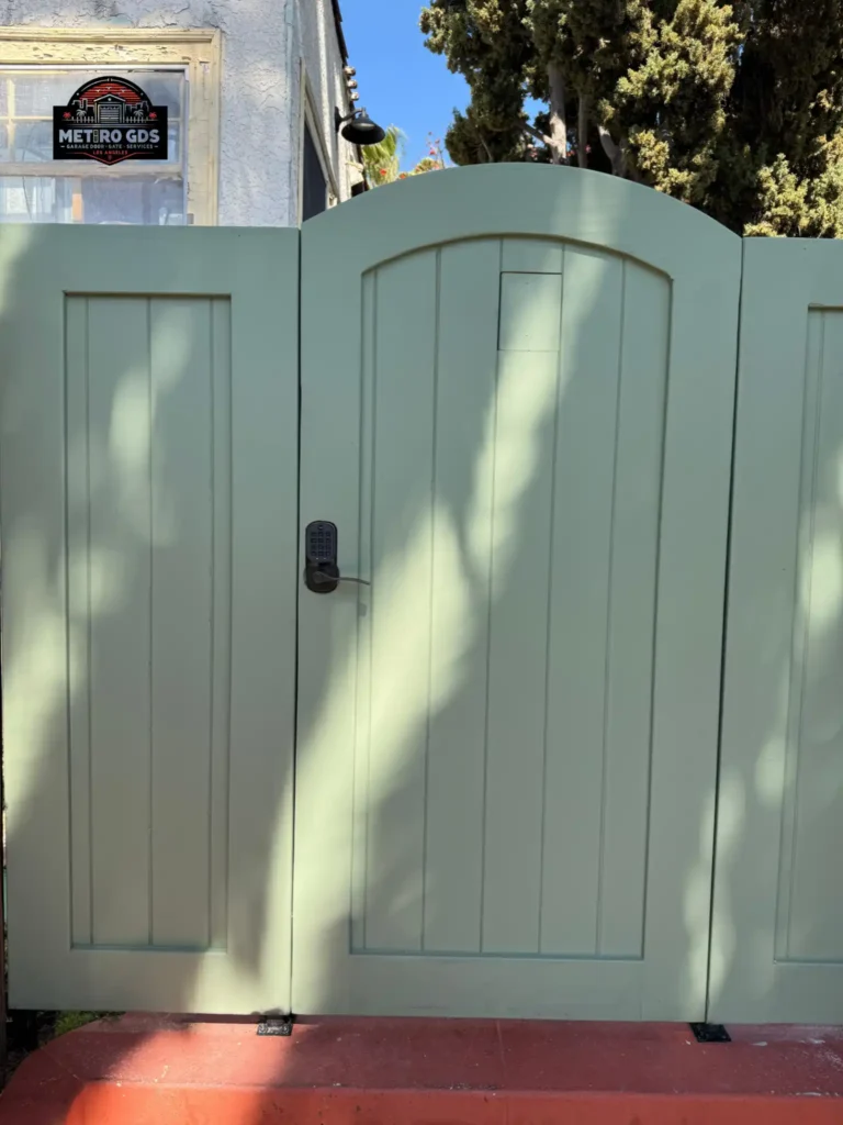 Light green custom entry gate with keypad lock installed by Metro GDS Inc