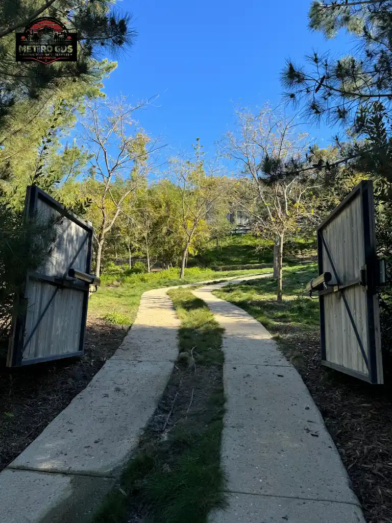 Driveway with open gates leading to a scenic property, installed by Metro GDS Inc