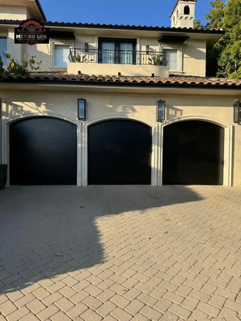 Elegant black arched garage doors installed by Metro GDS Inc