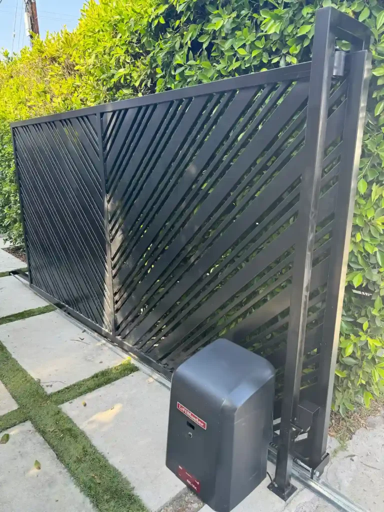 Modern black metal sliding gate with LiftMaster operator installed by Metro GDS Inc