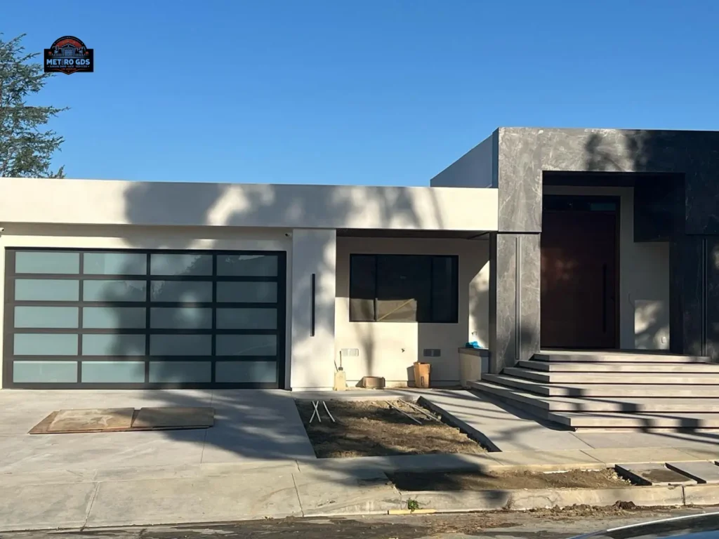 Stylish black and glass garage door installed by Metro GDS Inc