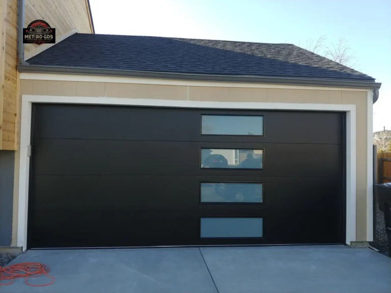 Contemporary black garage door with stylish windows, installed by Metro GDS Inc