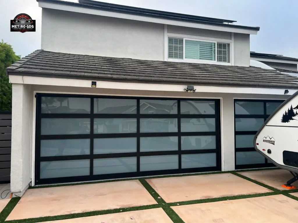 Stylish black and glass garage doors installed by Metro GDS Inc