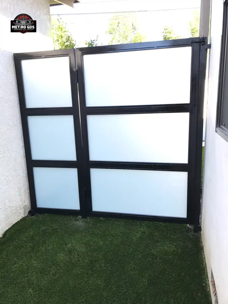 Sleek black metal frame with frosted glass gate installed by Metro GDS Inc