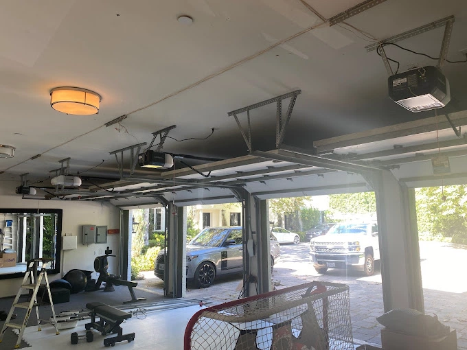 Open garage doors with installed automatic garage door opener by Metro GDS Inc