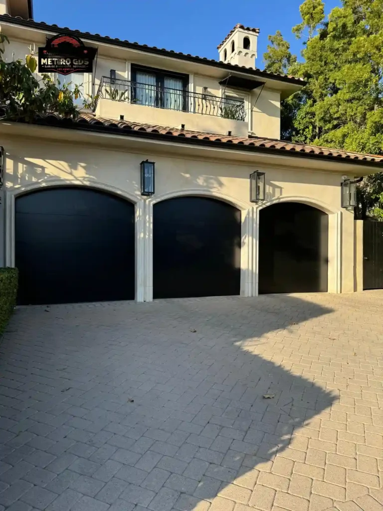 Modern black arched garage doors installed by Metro GDS Inc