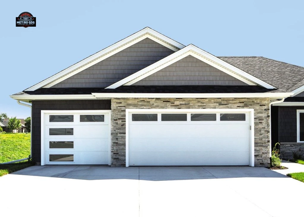 Sleek white garage doors with windows installed by Metro GDS Inc