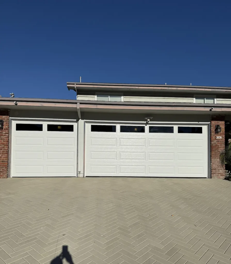 Completed garage door installation at a Rolling Hills, CA home with white doors and clear windows.