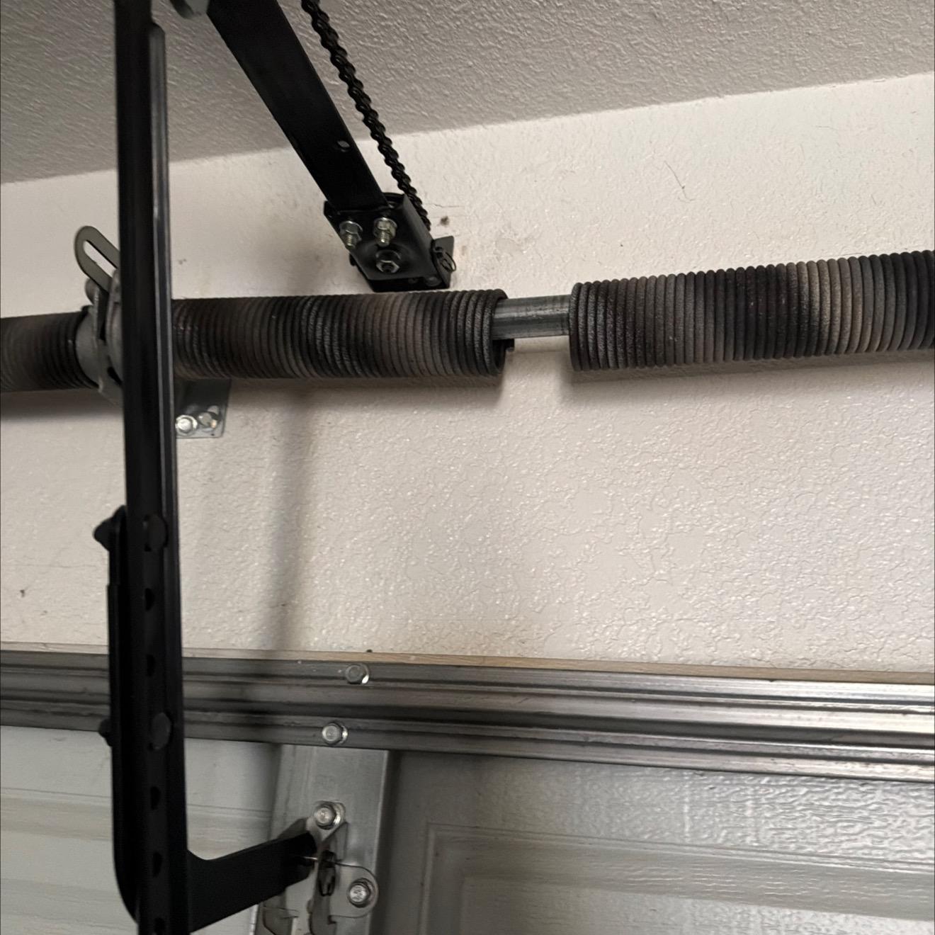 broken garage door torsion spring repaired by Metro GDS Inc