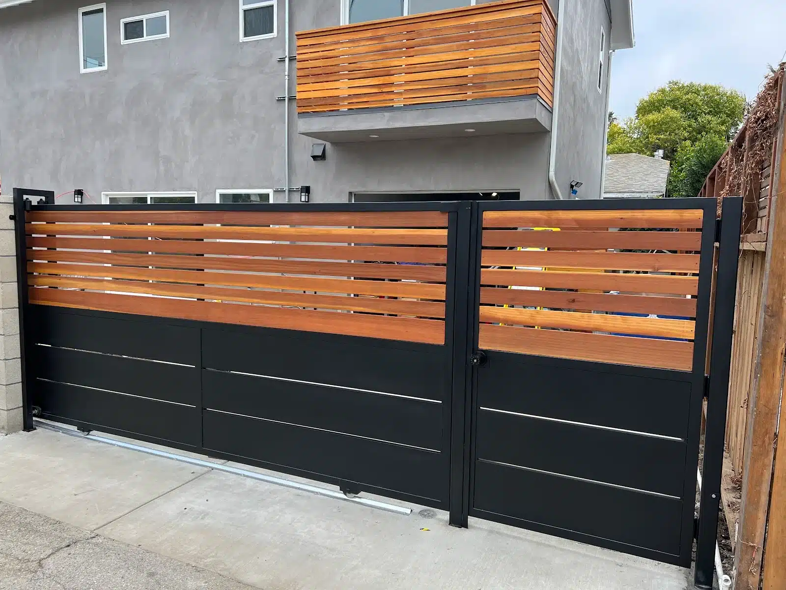 Black steel gate with horizontal wood slats