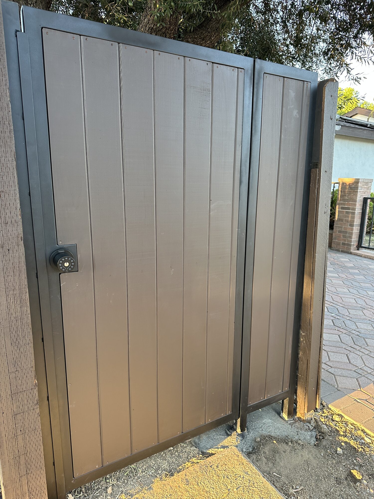 Gray steel panel pedestrian gate with steel frame fabricated and installed by Metro GDS in Los Angeles