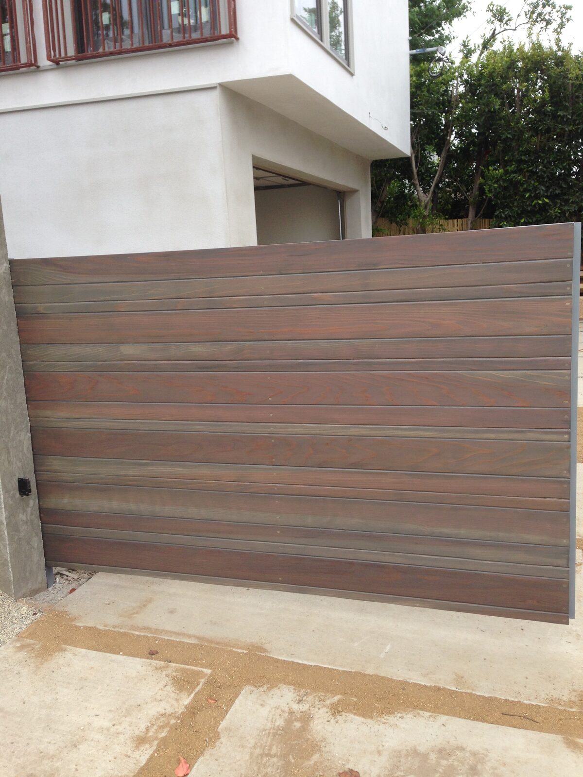 Horizontal wood slat sliding driveway gate installed by Metro GDS in Los Angeles