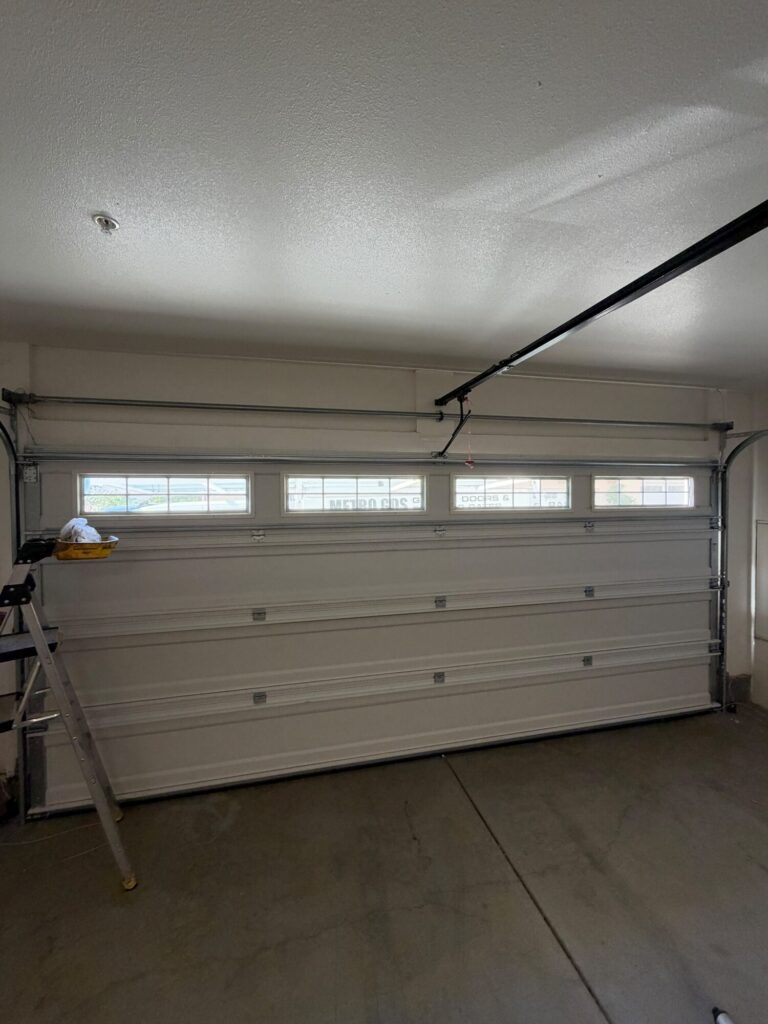 Garage door interior with opener rail and new torsion spring after conversion by Metro GDS in Los Angeles