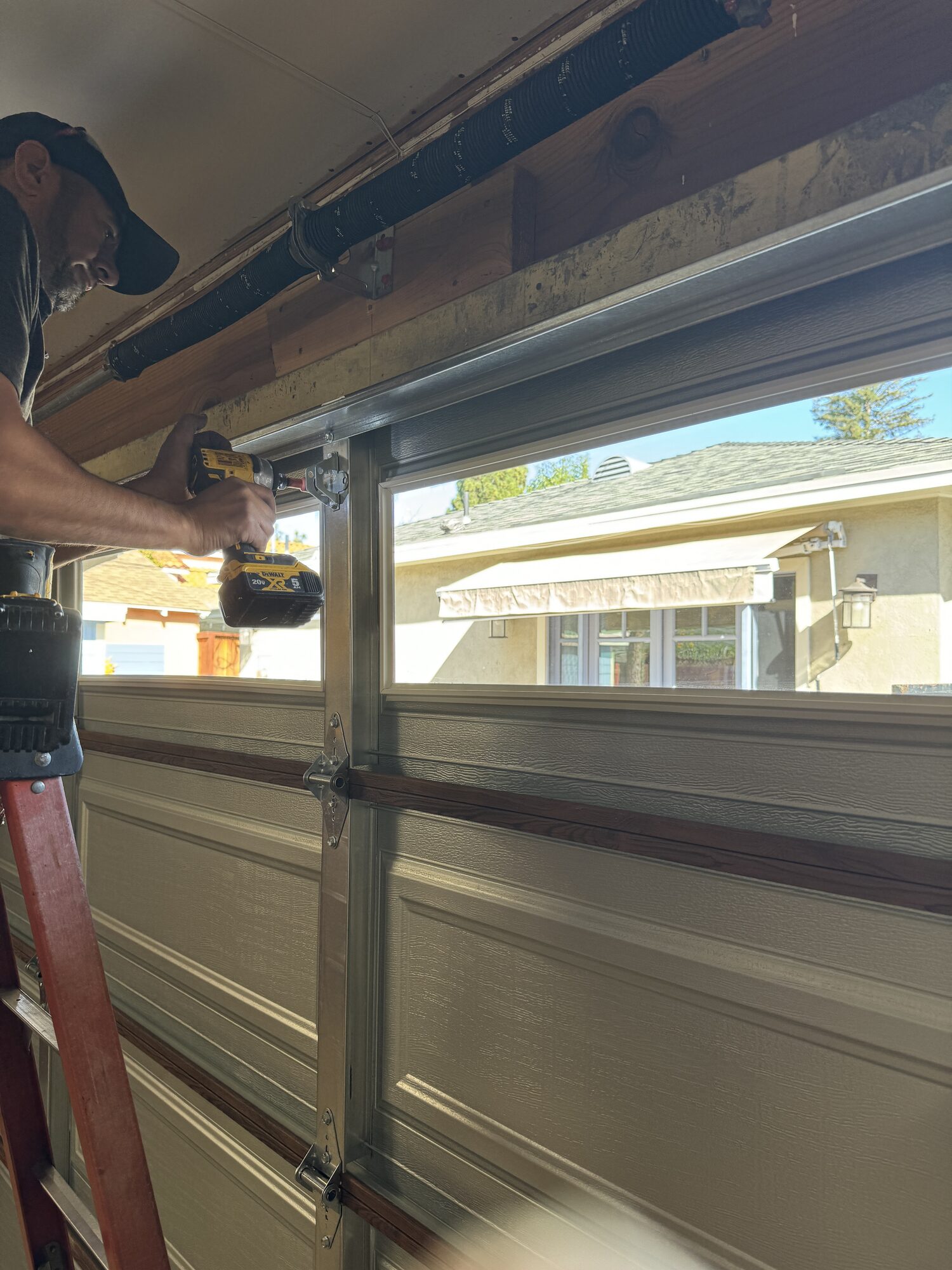 Close-up of garage door track and roller hardware serviced by Metro GDS in Los Angeles