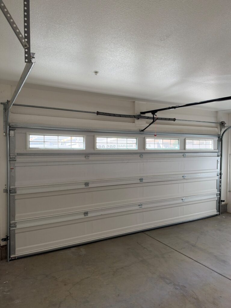 Sectional garage door interior with torsion spring and opener installed by Metro GDS in Los Angeles